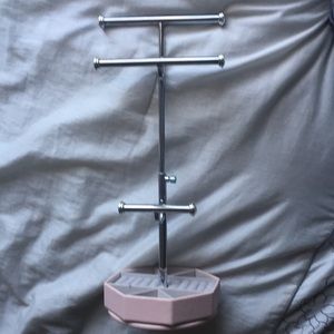 Pale pink rotating jewelry stand.